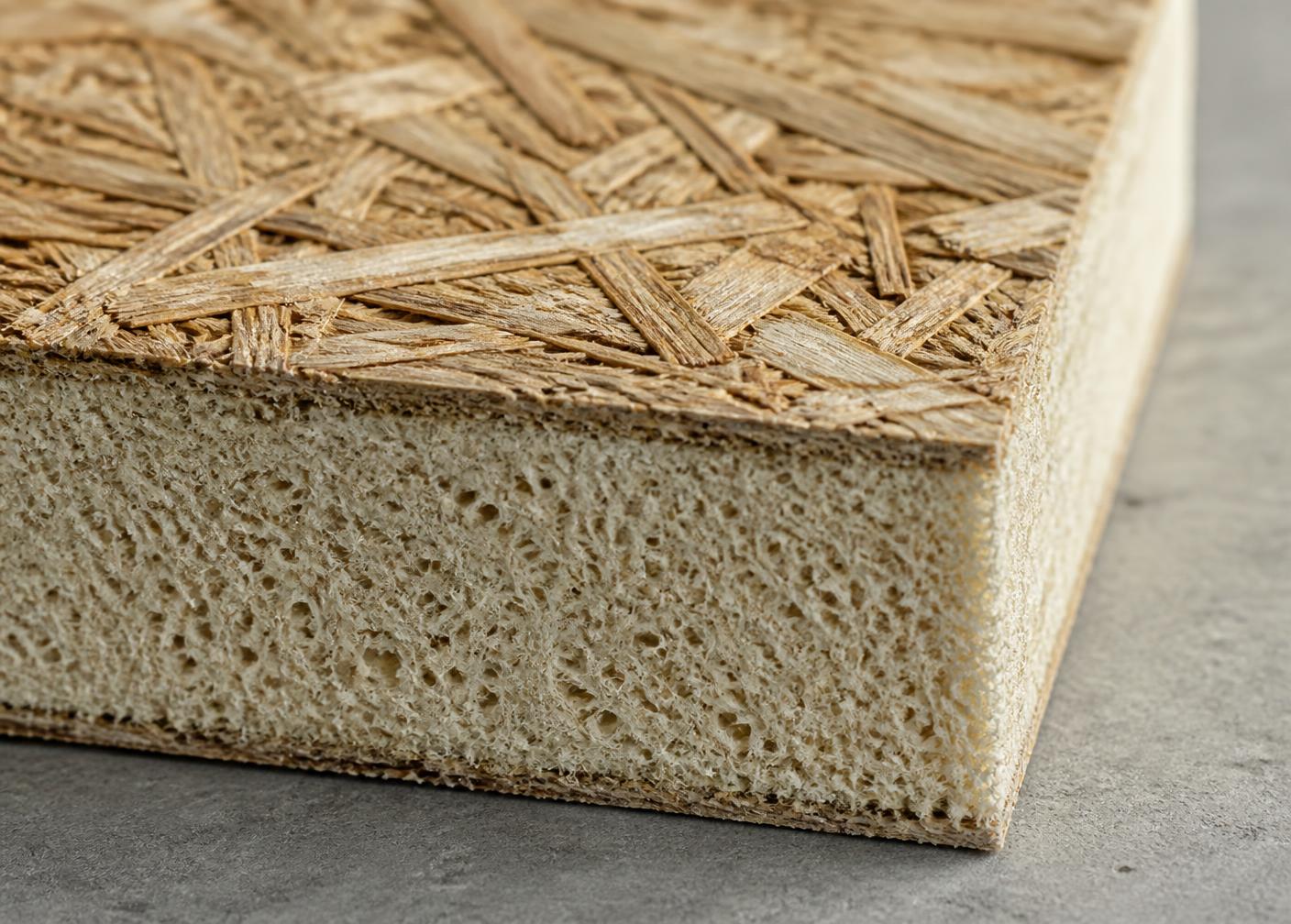 Macro photograph of a BioSIP panel edge showing reed strand facing over a cellular plant fibre insulation core